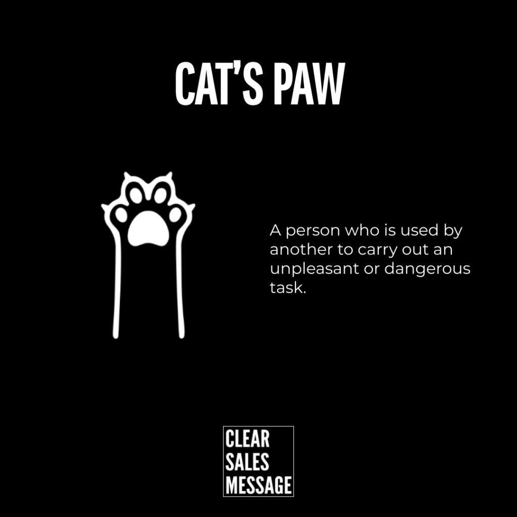 Cats paw white paw illustration on black background with the definition a person used to carry out an unpleasant or dangerous task