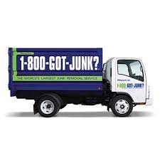 Blue and green junk removal truck with 1 800 got junk Branding on the side