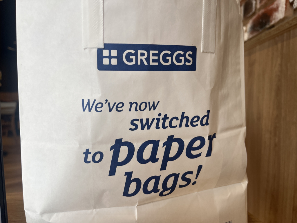 Img 6719 Greggs paper bag with blue logo and the message weve now switched to paper bags visible on the front