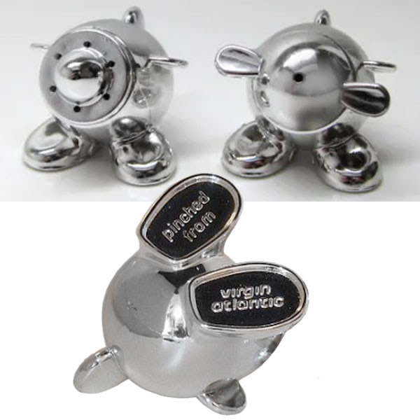 Img 6892 Three shiny chrome cartoon figures rounded bodies and big feet stand together the front figure has two black panels on its chest reading pinched from and wrong chemical