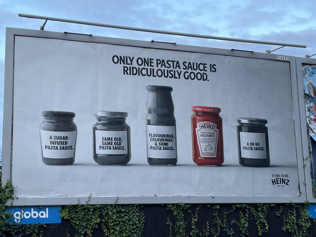 Outdoor billboard displaying four sauce jars and the bold caption only one pasta sauce is ridiculously good