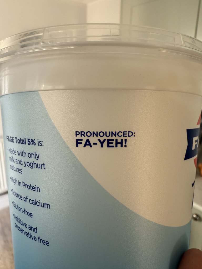 Img 5022 Close up of a yogurt container label with blue and white design showing a humorous pronunciation cue pronounced fa yeh
