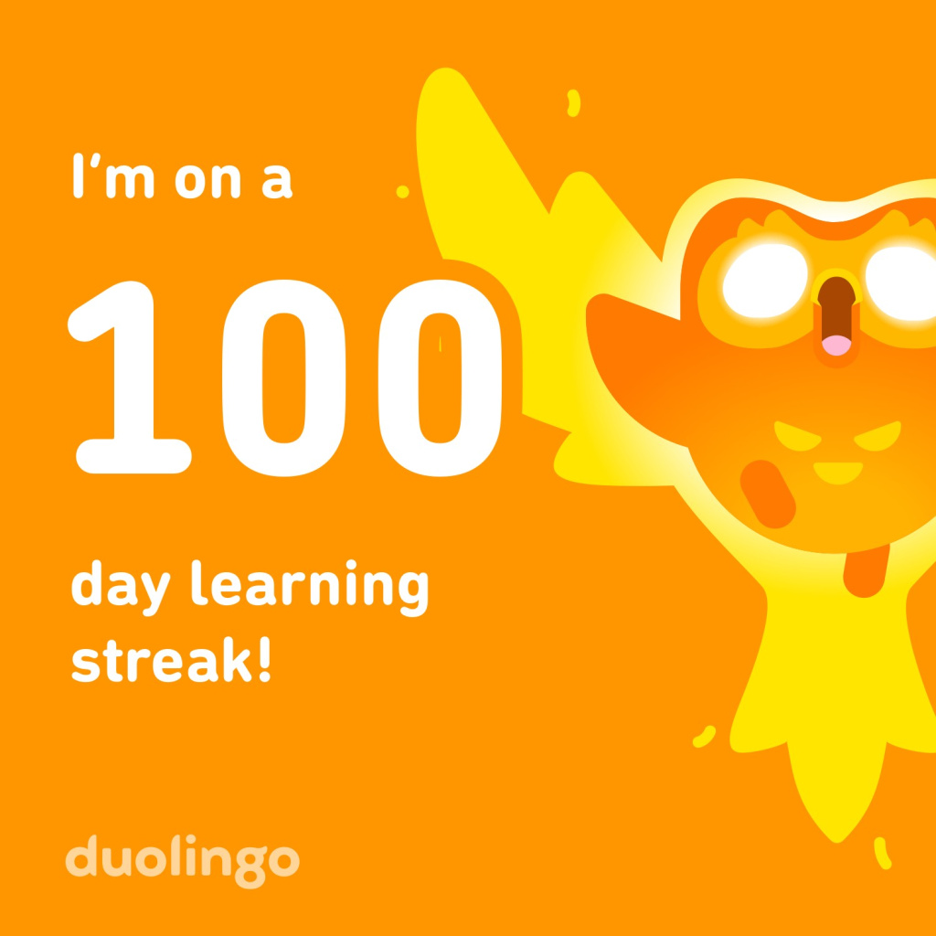 Duolingo celebrates a 100 day learning streak with bold white text on an orange background and a cheerful mascot on the right