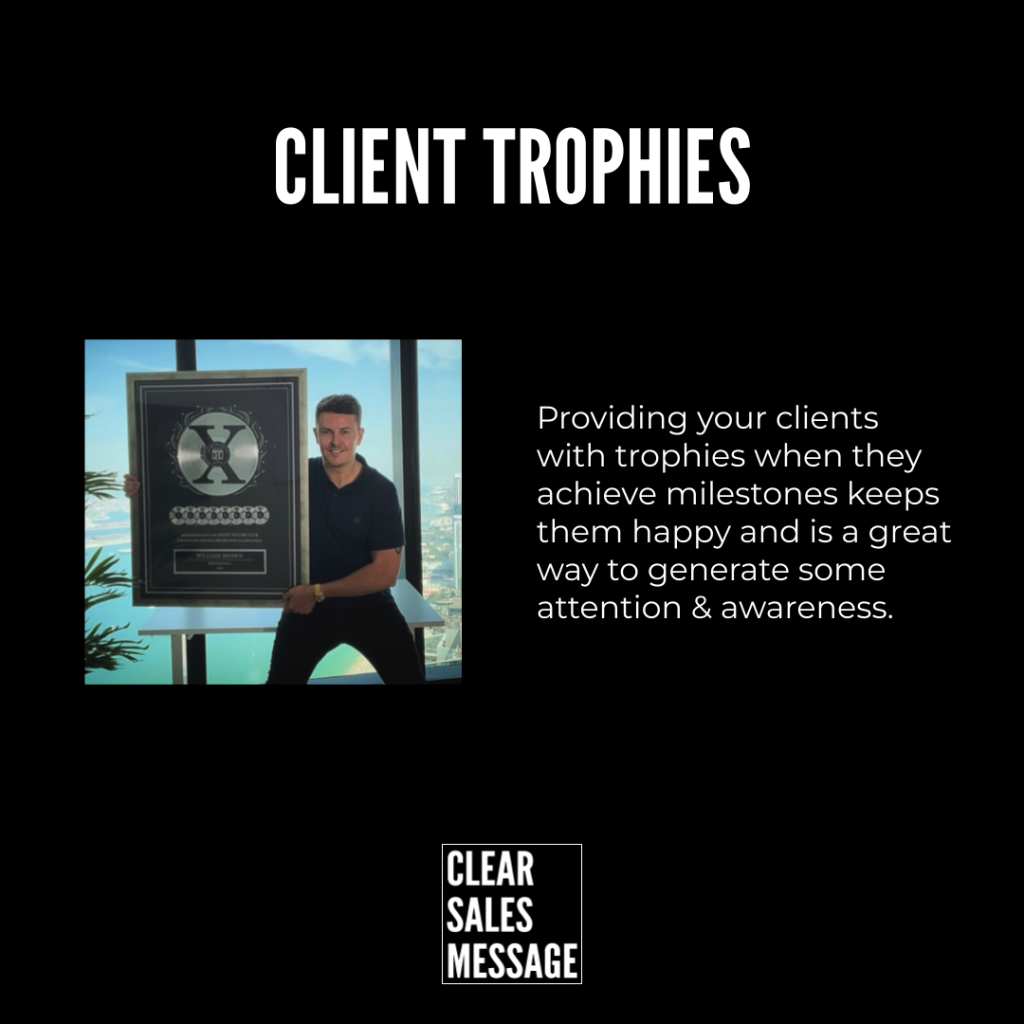 Hero slide a man posing with a large trophy plaque beside a text block about rewarding clients for milestones on a black background