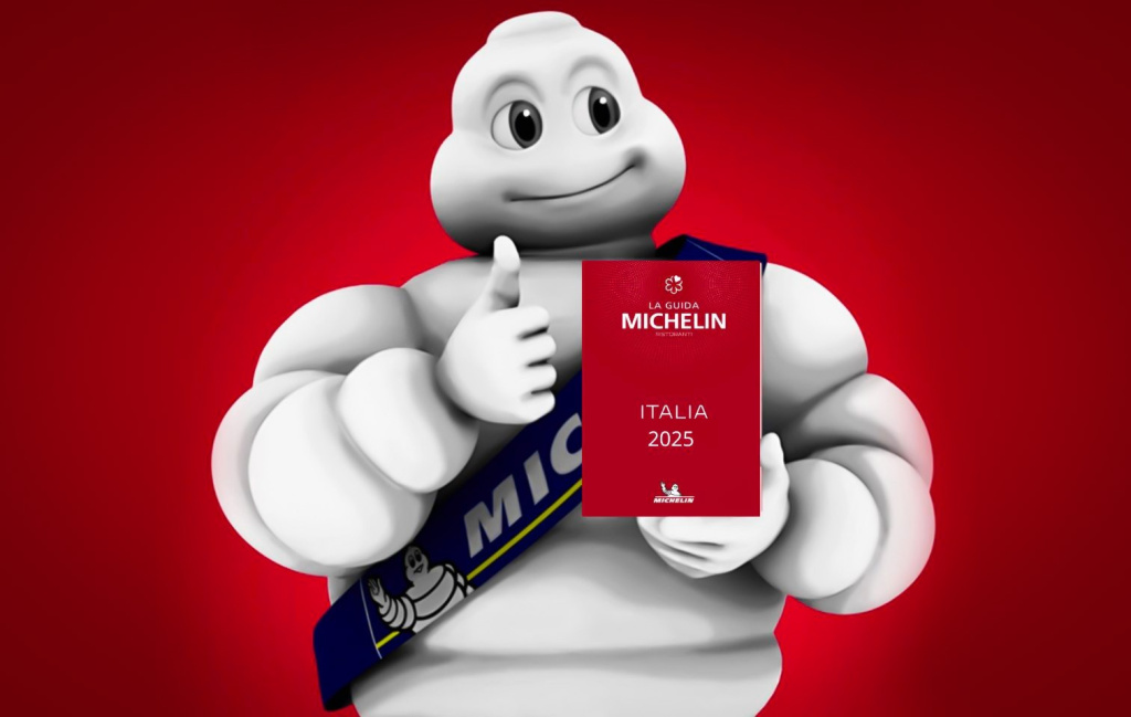 Michelin man in white holding a red italia 2025 guidebook with a blue sash and michelin logo against a red background