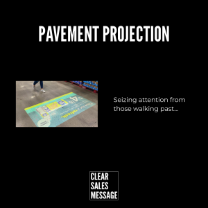 Slide titled pavement projection on a black background with a sidewalk projection image on the left and the caption seizing attention from those walking past on the right bottom logo reads clear sales message