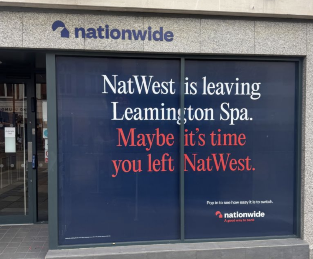 Screenshot 2025 09 03 at 08 01 07 Storefront window ad for natwest announcing departure from leamington spa bold white and red text reads natwest is leaving leamington spa Maybe its time you left natwest with a nationwide logo above