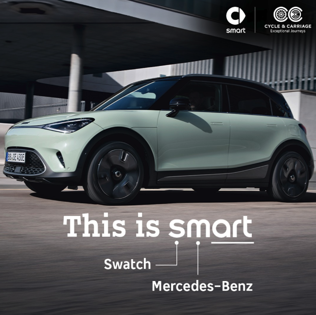Screenshot 2025 09 15 at 15 18 34 Mint green smart car driving near a modern building overlay text reads this is smart with labels for swatch and mercedes benz in the corner advertisement