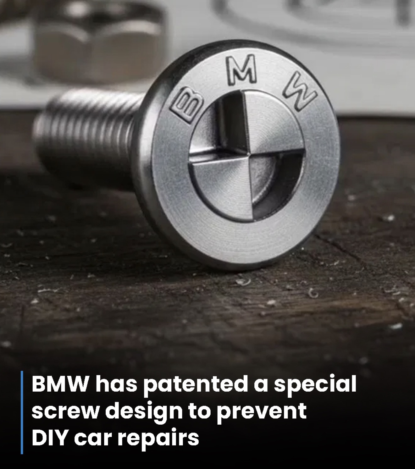 Close up of a silver bolt with bmw lettering on the head illustrating a patented special screw design to deter diy car repairs