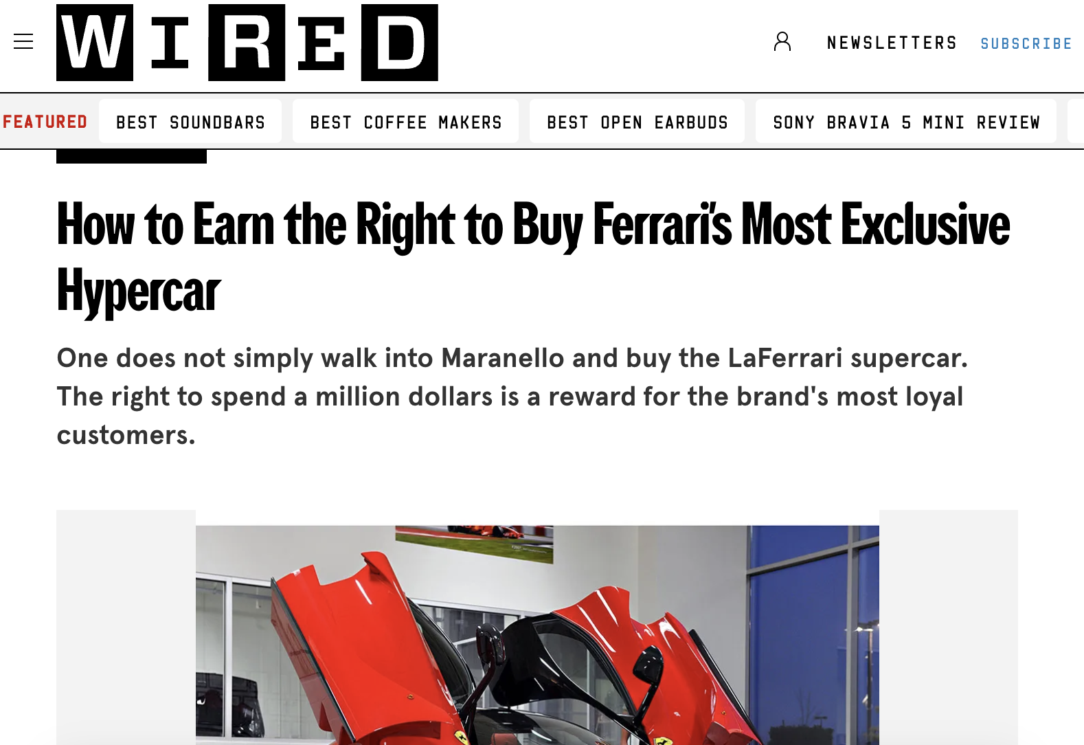 Screenshot 2026 02 07 at 19 31 33 Red ferrari laferrari hypercar on display with its gull wing doors open in a showroom