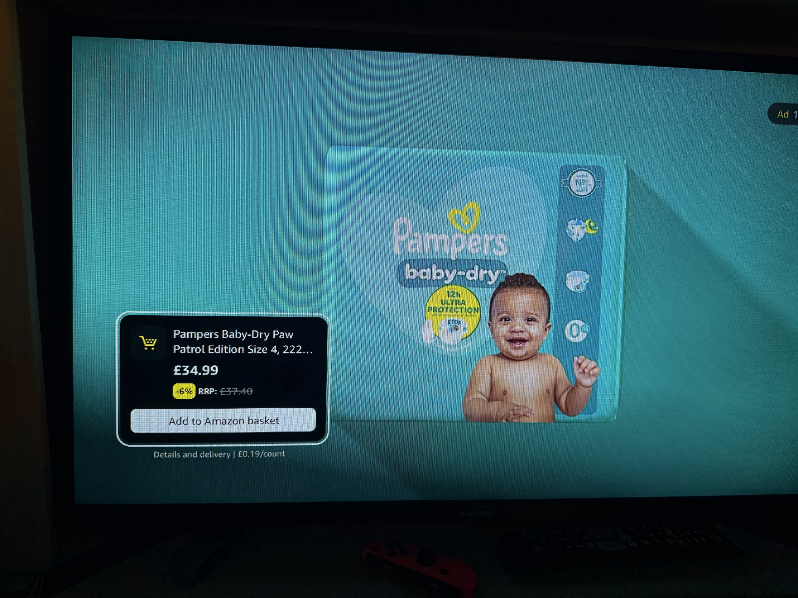 Smart tv advert for pampers baby dry with a live add to amazon basket purchase card shown alongside the product