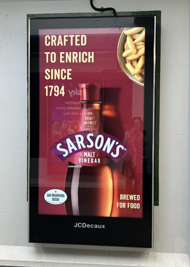 Poster advertisement for sarsons malt vinegar brewed for food with fries shown in a bowl and text crafted to enrich since 1794 on a dark frame