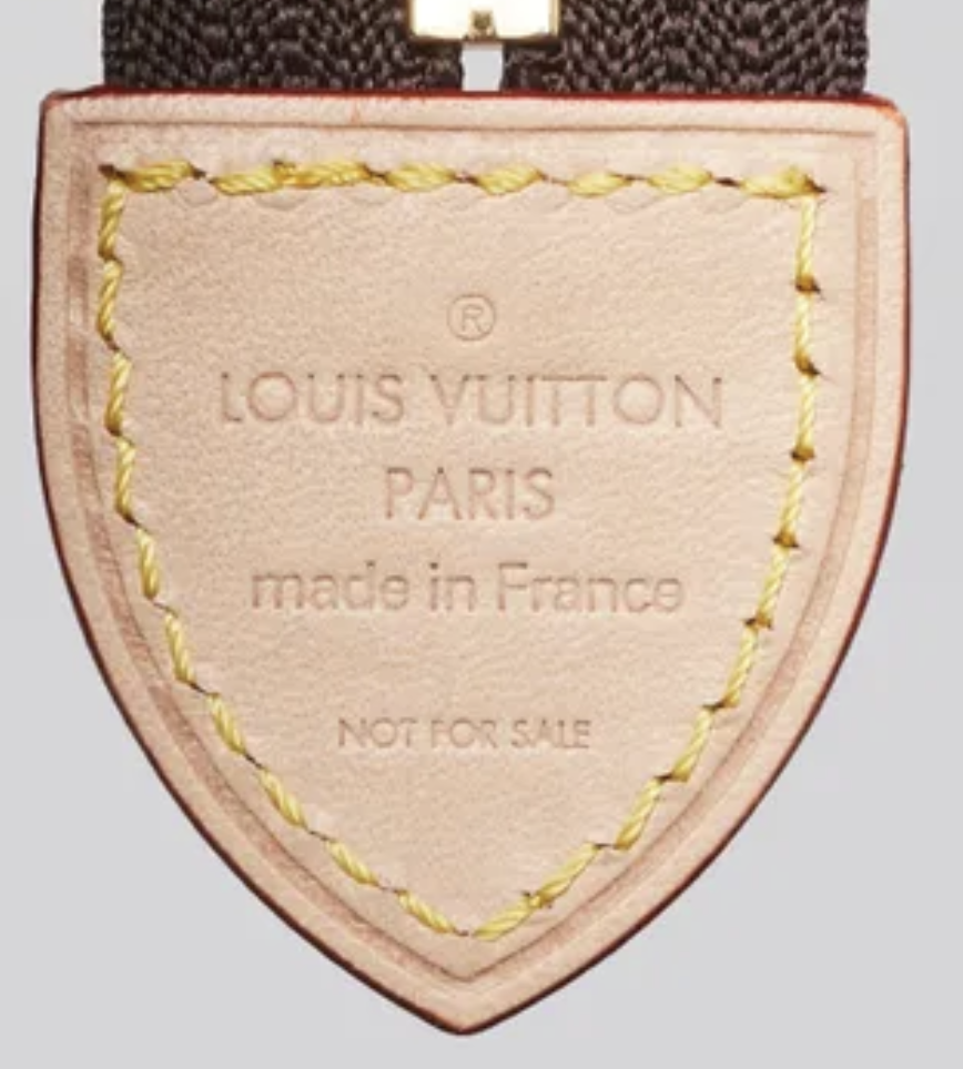 Louis vuitton leather shield tag with embossed louis vuitton paris made in france and not for sale text yellow stitched edge