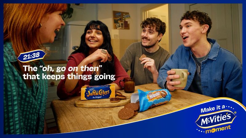 Four friends in a bright kitchen share biscuits and tea smiling as they enjoy a mcvities moment advertisement