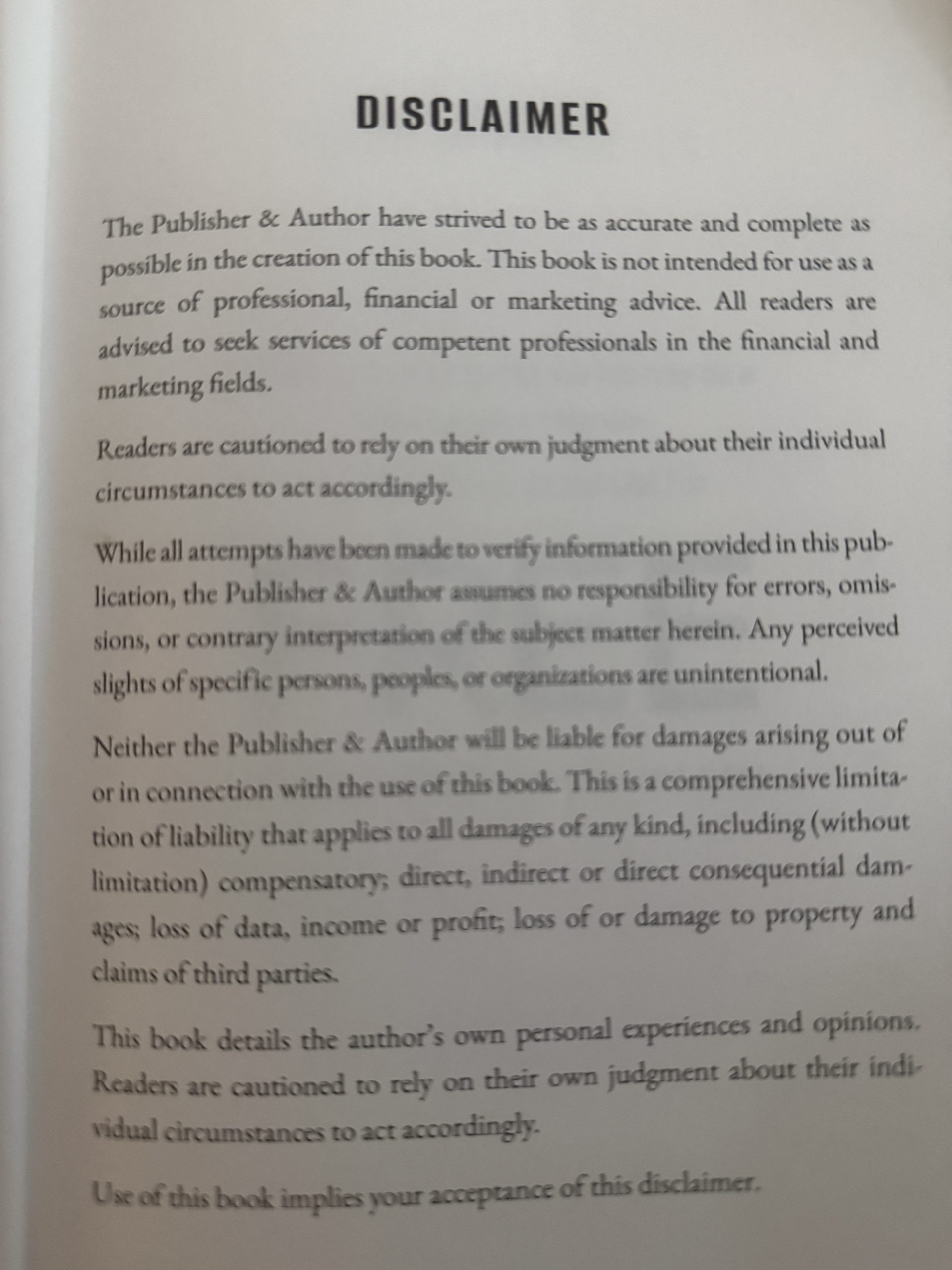 Disclaimer page with a bold disclaimer header and dense paragraphs of fine print text in a book